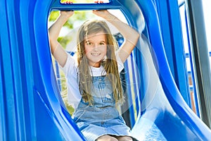 beautiful smiling cute girl on a playground