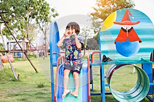 Beautiful smiling cute girl on a playground