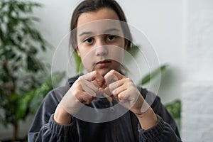 Beautiful smiling deaf girl using sign language.