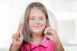 Beautiful smiling deaf girl using sign language