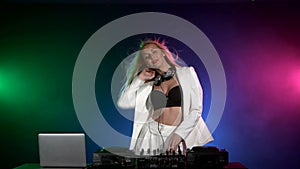 Beautiful, smiling, dj girl in white jacket