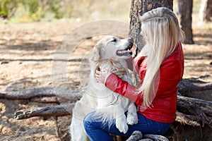 Beautiful smiling dog walking with owner outdoors. Pet concept.