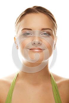 Beautiful smiling face of young woman with healthy clean skin