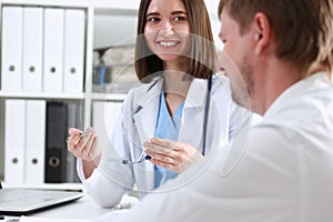 Beautiful smiling female doctor hold