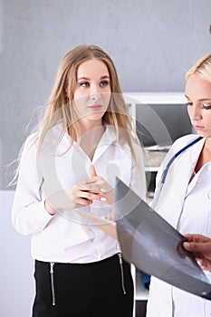 Beautiful smiling female doctor hold silver pen