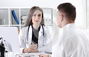 Beautiful smiling female doctor hold silver pen