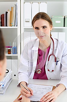 Beautiful smiling female doctor hold silver pen