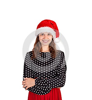 Beautiful smiling female model in dress. emotional girl in santa claus christmas hat isolated on white background. holiday concept