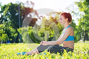 Beautiful smiling girl in activewear relax in park