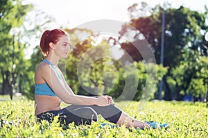 Beautiful smiling girl in activewear relax in park