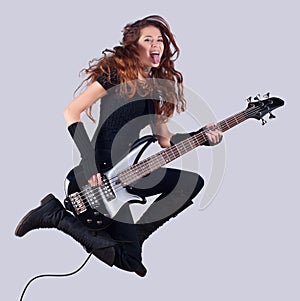 Beautiful smiling girl with bass guitar