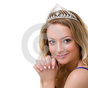Beautiful smiling girl with diadem on a white