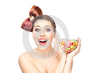 Beautiful smiling girl eating sweets from a bowl
