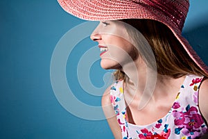 Beautiful smiling girl in a hat in profile