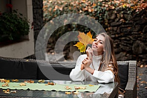 Beautiful smiling girl with long hair, red lips, wearing stylish jacket posing in autumn street. Outdoor portrait