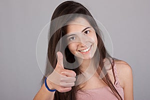 Beautiful smiling girl making ok sign