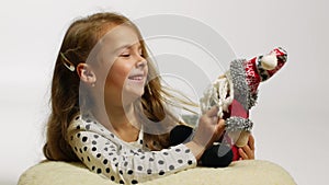 Beautiful smiling girl with Santa toy having fun