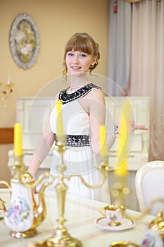 Beautiful smiling girl stands next to classic