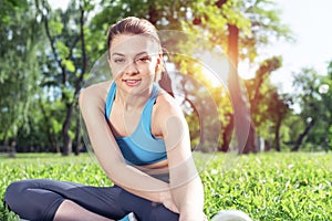 Beautiful smiling girl stretching before fitness
