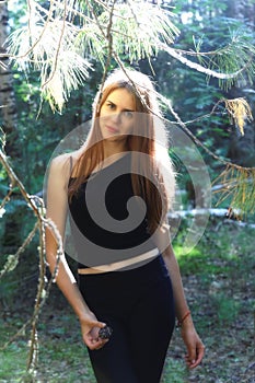 Beautiful smiling girl walking through the summer Siberian taiga