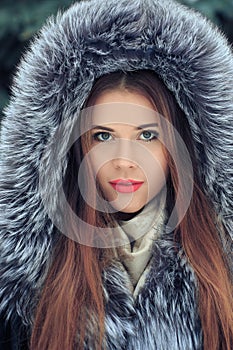 Beautiful smiling girl . Winter portrait. fur hood