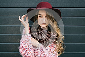 Beautiful smiling happy woman in hat. Retro fashion. Summer hat with large brim over dark blue background