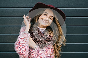 Beautiful smiling happy woman in hat. Retro fashion. Summer hat with large brim over dark blue background