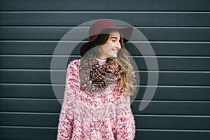 Beautiful smiling happy woman in hat. Retro fashion. Summer hat with large brim over dark blue background