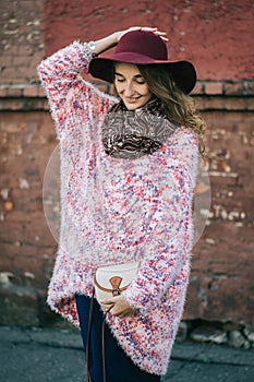 Beautiful smiling happy woman in hat. Retro fashion. Summer hat with large brim over wall background