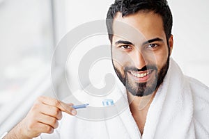 Beautiful Smiling Man Brushing Healthy White Teeth With Brush. H