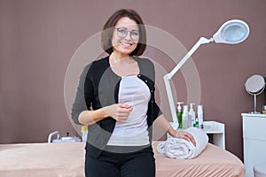 Beautiful smiling mature woman client of beauty salon, posing looking at camera
