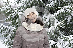 Beautiful smiling middle-aged woman in the winter outdoors. Winter concept