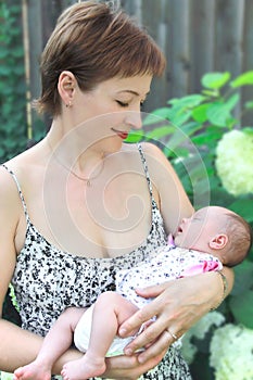 Beautiful smiling mother looking at baby