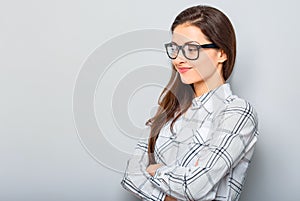 Beautiful smiling positive successful business woman profile in glasses looking confidently in white shirt and long hair. Closeup