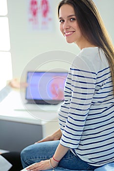 Beautiful smiling pregnant woman with the doctor at hospital