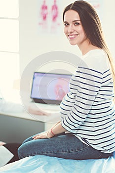 Beautiful smiling pregnant woman with the doctor at hospital