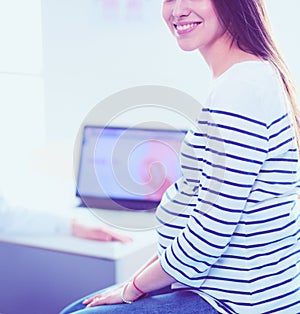 Beautiful smiling pregnant woman with the doctor at hospital