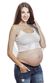Beautiful smiling pregnant woman at a late term. Isolated on a white background.