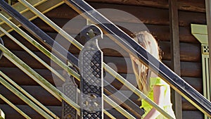 Beautiful smiling teen girl walking up wooden stairs