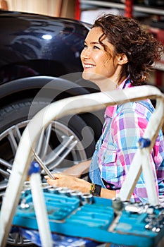 Beautiful smiling woman car mechanic photo