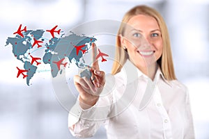 Beautiful smiling woman drawing an airplane routes on world map