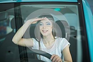 Beautiful Smiling woman driving car looking streight front