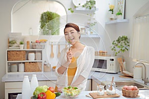 Beautiful Smiling Woman Eating Fresh Organic Vegetarian Salad In Modern Kitchen