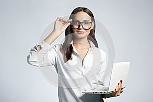 Beautiful smiling woman in glasses. Student girl with laptop