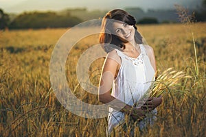 Beautiful smiling woman in a golden field