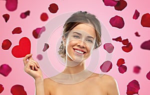 Beautiful smiling woman holding red heart