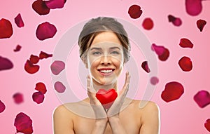 Beautiful smiling woman holding red heart