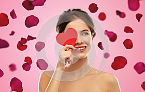 Beautiful smiling woman holding red heart