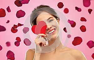 Beautiful smiling woman holding red heart