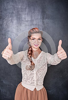 Beautiful smiling woman showing thumbs up